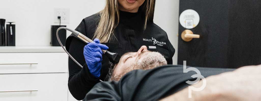 Man getting medical aesthetic treatment from Aesthetician in Grand Blanc, Michigan.